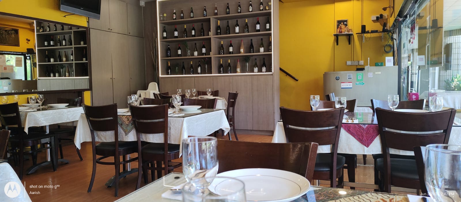 The main dining room with set tables and yellow walls
