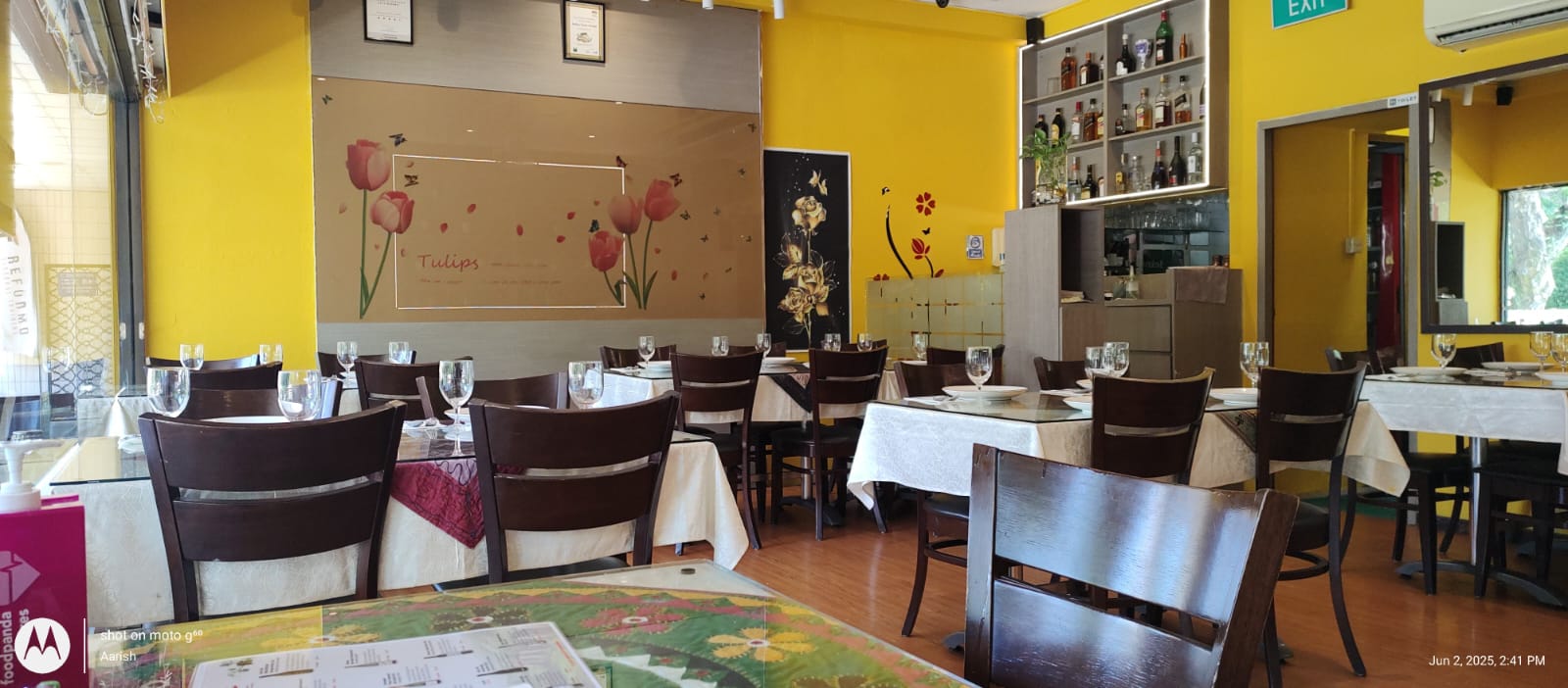 The bright yellow main dining hall with set tables